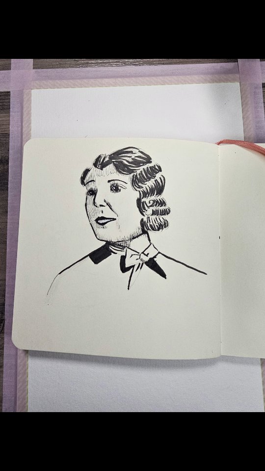 Ink portrait sketch of vintage woman in sketchbook